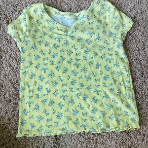 Yellow shirt with flowers.